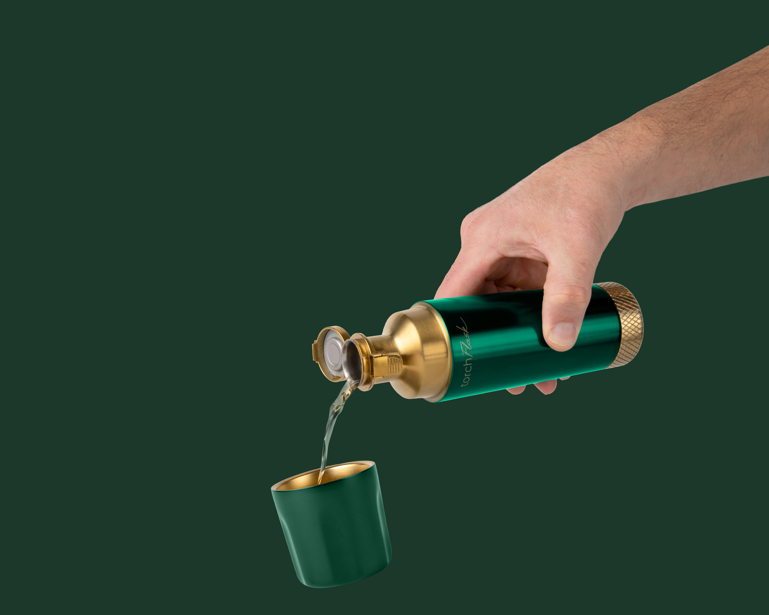 Hand pouring liquid from a green bottle